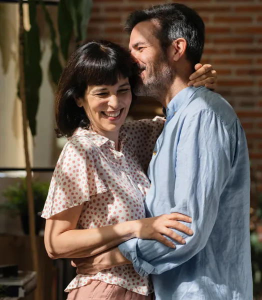 Man and Woman embracing while smiling.