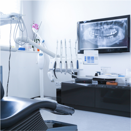 a dentist's office with dental equipment and a television