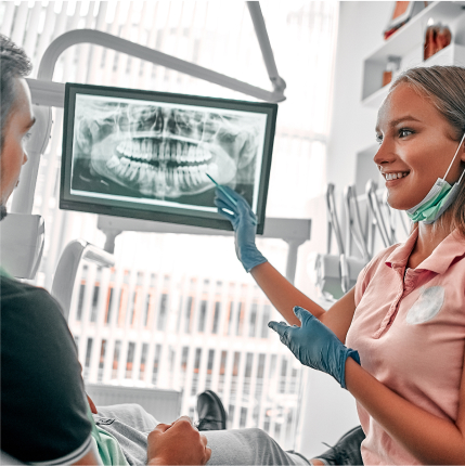 a woman in a dentist's office talking to a patient about x-rays