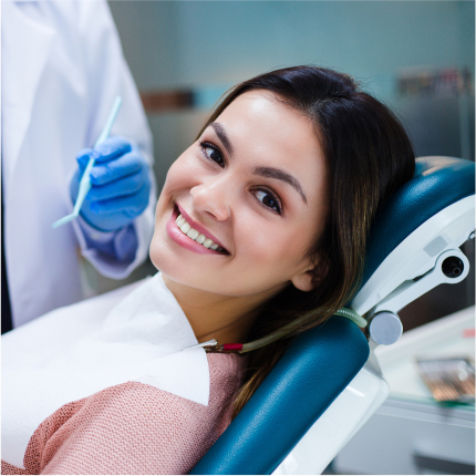 Smiling woman in dental chair during a restorative dentistry visit..