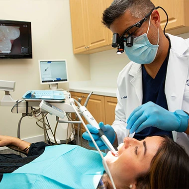 Dr. del Castillo using intraoral scanner during dental exam at Minorca Smiles.